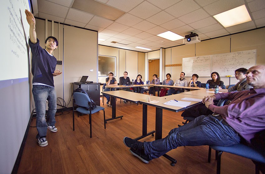 Graduate students present their research in seminars (here led by Prof. Patrick Francois, far right).